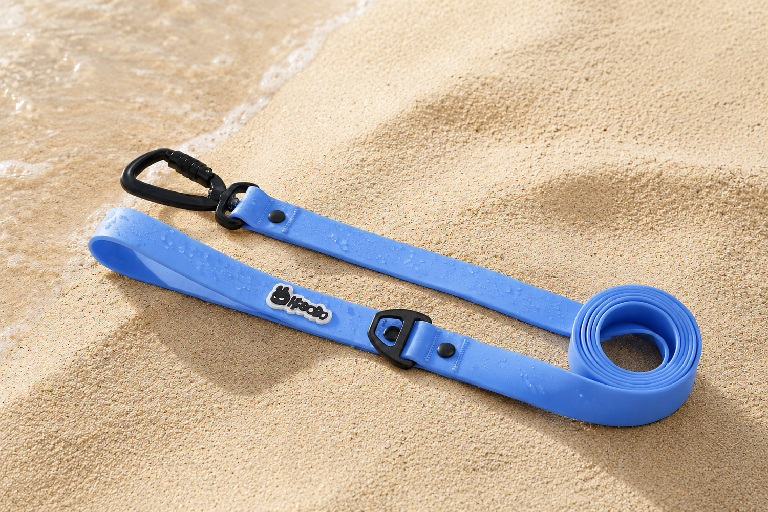 RBOBO waterproof dog leash in blue resting on wet beach sand, featuring durable hardware and easy-clean waterproof material for outdoor adventures.