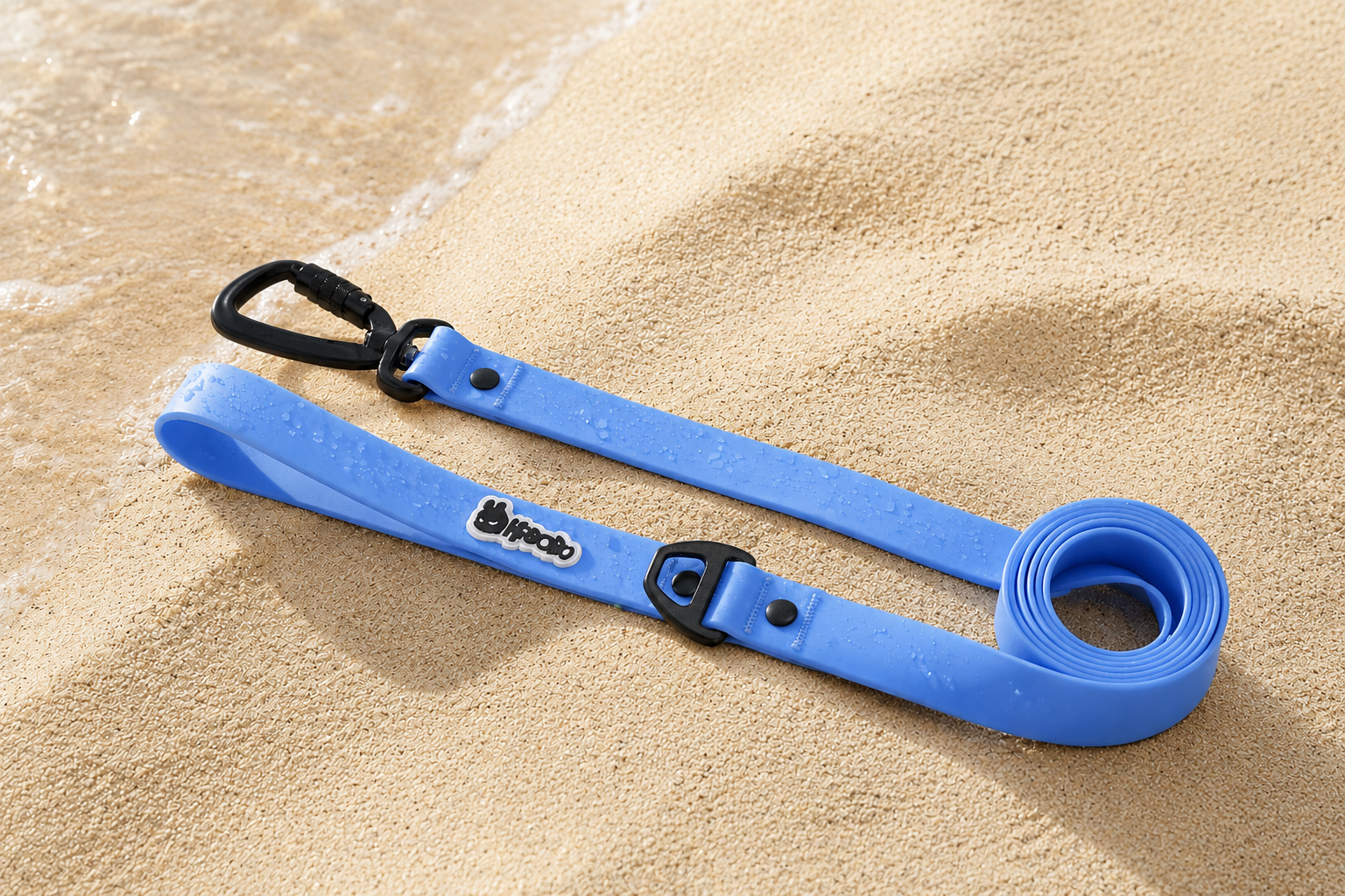 RBOBO waterproof dog leash in blue resting on wet beach sand, featuring durable hardware and easy-clean waterproof material for outdoor adventures.
